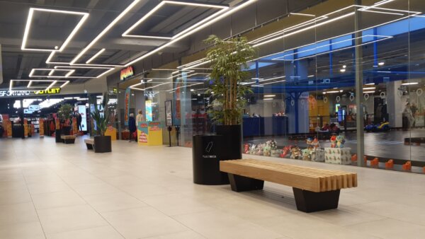 a bench with a wooden seat in the mall