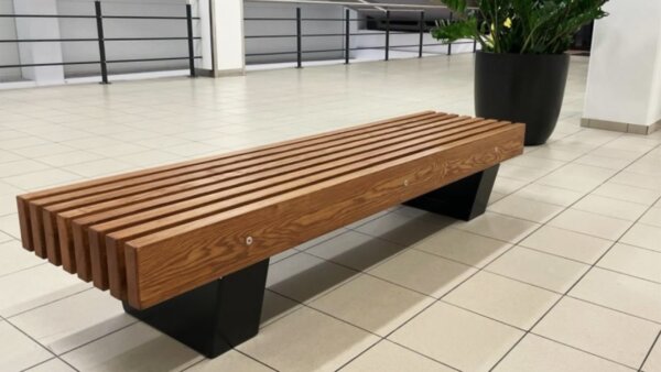 backless seat bench with massive wooden seat at shopping mall