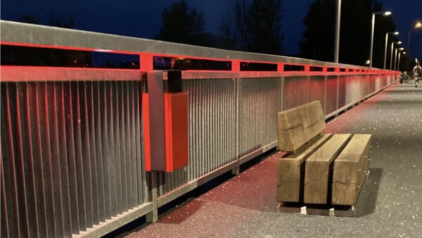 Outdoor trash bin attached to the bridge railing